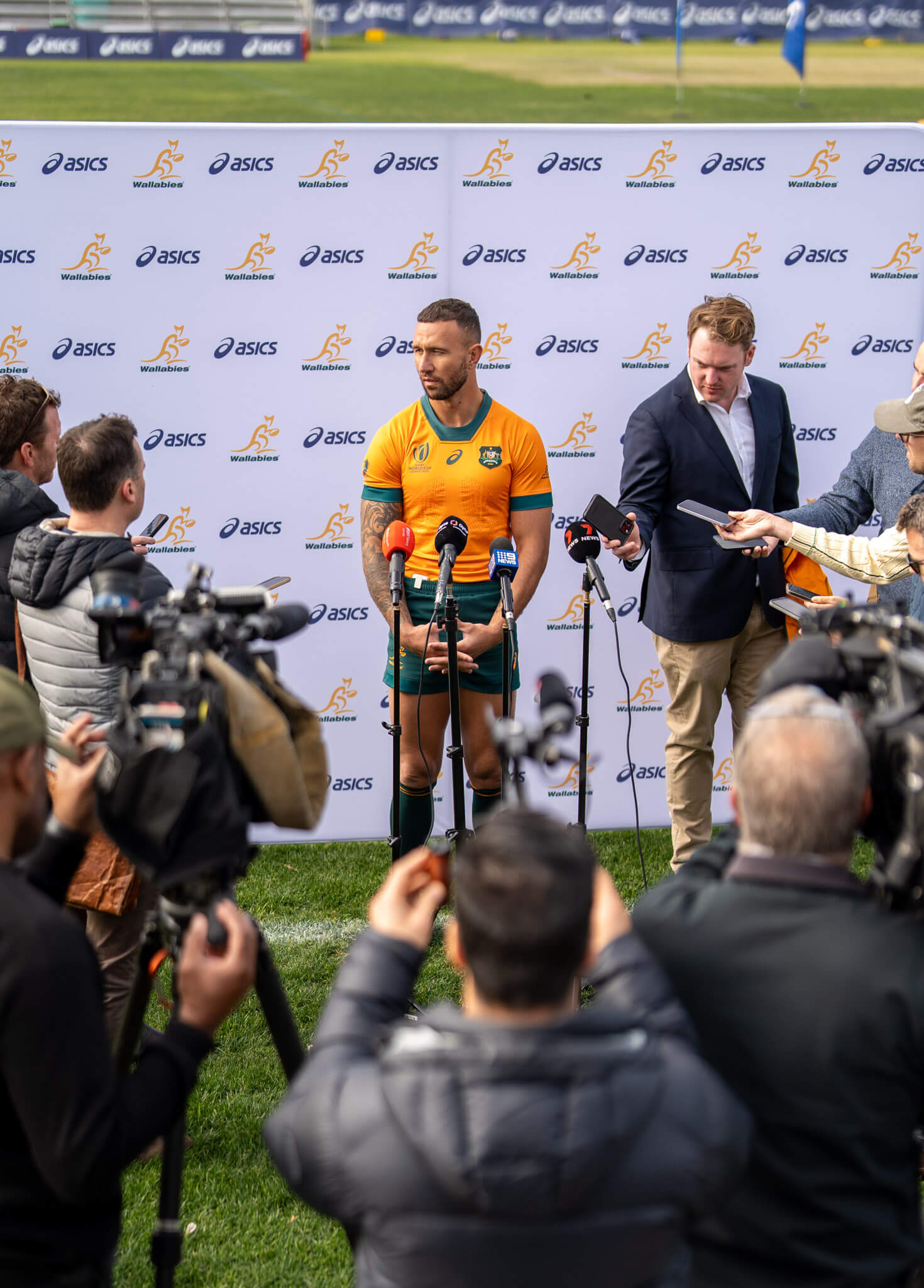 Wallabies player Quade Cooper interviewed in front of media.