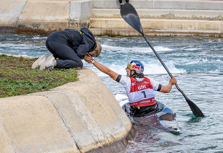 Jess Fox celebrating 10th world title win in the water with mum.