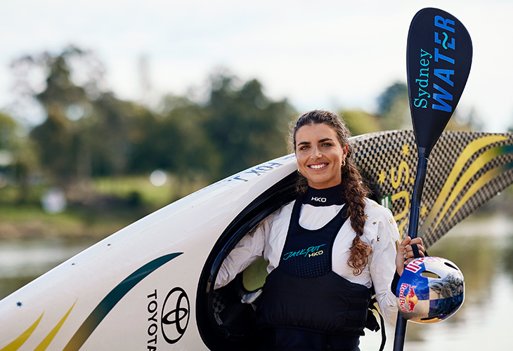 Jess Fox posing with canoe.