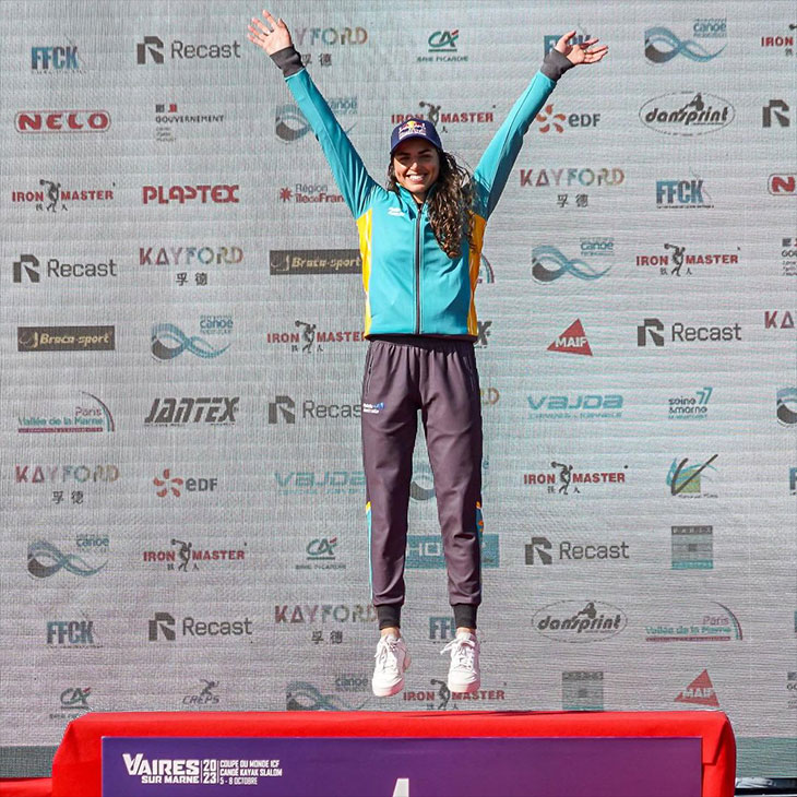 Jess Fox celebrating 10th world title win on the podium.