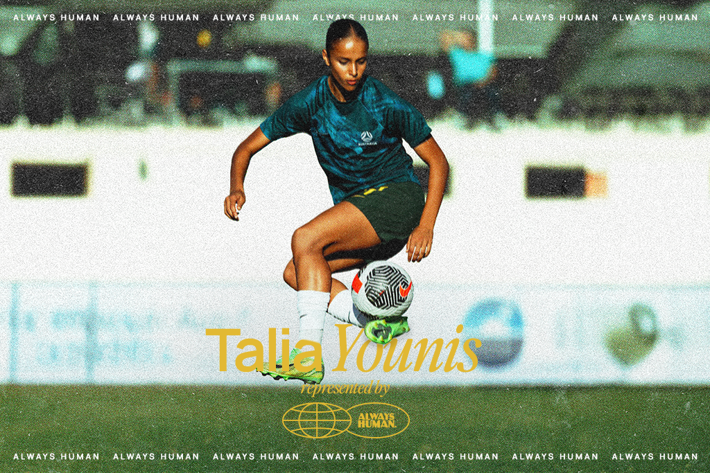 Female soccer player in a teal jersey kicks a ball on a grass field; overlay shows 'Talia Younis' with 'Always Human' branding.